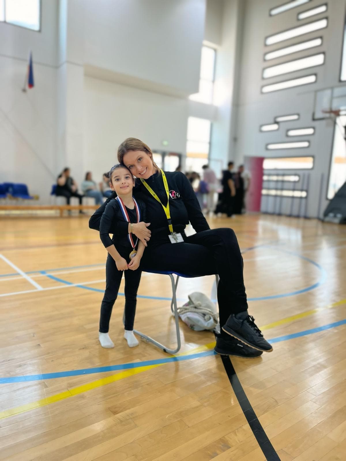 Coach Elena hugging a student